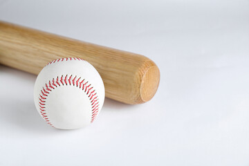 Wooden baseball bat and ball on white background. Sports equipment