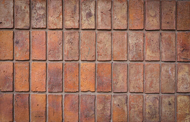 Brick wall. Brickwork from an old brick in a rustic style. Structure and pattern of the destroyed stone wall. Copy space 