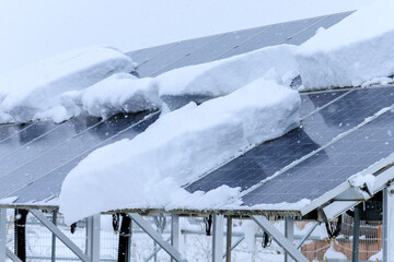 雪が積もった太陽光パネル　発電　雪国　冬