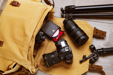 professional DSLR camera and lenses in a canvas bag for the work of a professional photographer