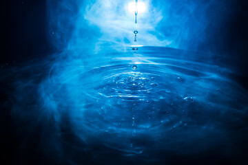 Water splash on dark foggy background. Selective focus.