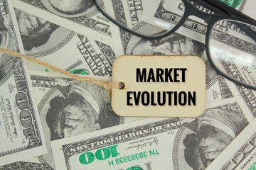 glasses and a wooden tag with the word Market Evolution. the concept of market evolution