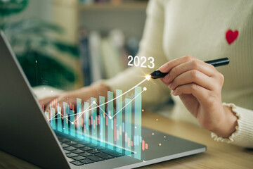 Businesswomen analyze profitability of working companies with digital augmented reality graphics, positive indicators in 2023, and corporate future growth year 2022 to 2023. Development to success