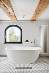 Bathroom interior with white bath near window