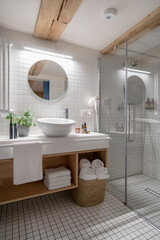 Fototapeta na wymiar Wide shower cabin in white tiled bathroom