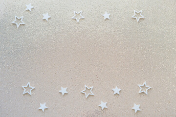 Gold glitter party background with white stars. shine