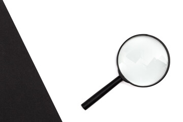 A magnifying glass against colored background, flat lay, minimal creative concept.