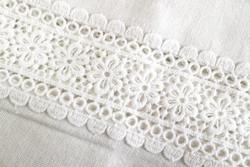 close up of white knitted fabric white flower lace material