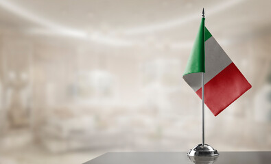 A small Italy flag on an abstract blurry background