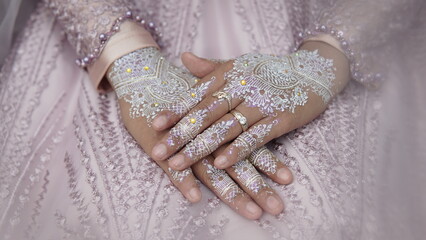 close-up of beautiful woman with henna tattoo on her hand. Beautiful Bridal Hands with henna and...