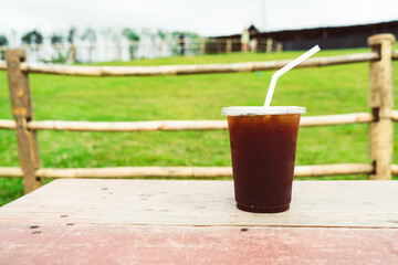 americano coffee on wood table with Mountain hill View background