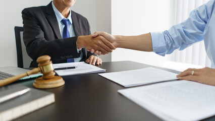 Lawyer and justice concept, Businessman and senior lawyer shaking hands after successful agreement