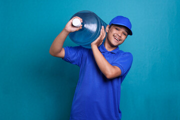 Asian delivery guy in blue uniform work as dealer courier carrying a water gallon