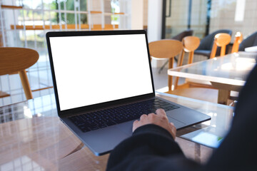 Mockup image of a woman using and touching on laptop computer touchpad with blank white desktop screen