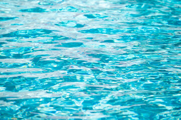 Ripped water in swimming pool. Surface of blue swimming pool, background of water.