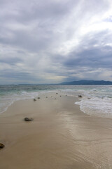 beach and sea with mountains in the back