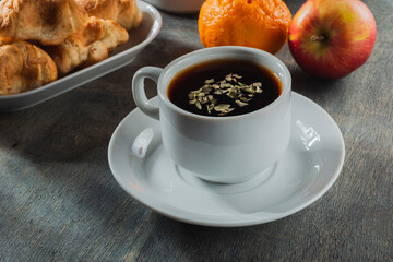 Morning breakfast - tea and light snack on a background dark