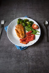 Popular food chicken steak and vegetables in a plate. Top view.