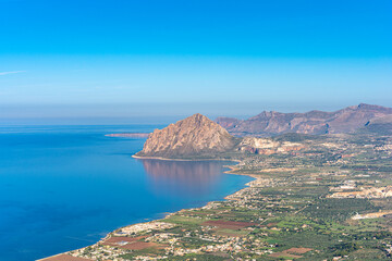 Fototapeta na wymiar Scenic outlook of the vast natural bay of the Gulf of Bonagia in western Sicily on the Tyrrhenian Sea from Monte Erice to Monte Cofano, a mountain located on a headland on the coast of western Sicily 