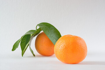 Two oranges on a light background