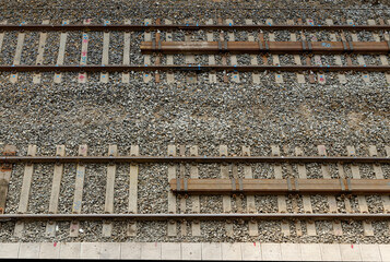 Details of two train tracks at the platform of the railway station.