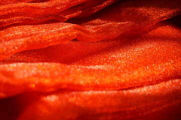 Selective close up satin cloth show abstract red gradient background. Abstract red glitter backdrop.