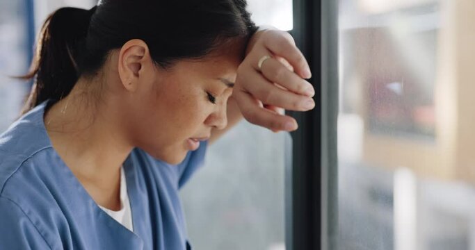 Doctor woman, burnout and anxiety in hospital, workplace and tired in healthcare job, stress or headache. Nurse, sad and exhausted in medical service, clinic or depression in health career by window
