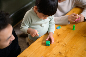 粘土で遊ぶ幼児と家族　俯瞰