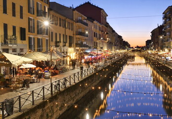 Naklejka premium View of the crowded Naviglio Grande district in Milan and christmas lights.