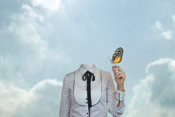 surreal headless woman with a butterfly leaning on her hand, concept of fantasy and freedom