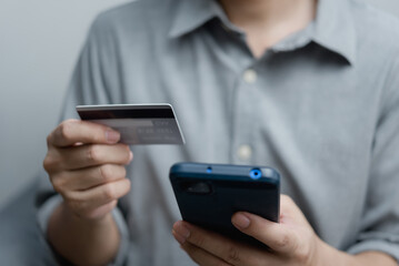 businessman using credit card and smartphone login to internet bank.Online shopping, e-commerce, internet banking, and financial transactions payments via e-bank application concept.