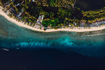 Tropical beach and ocean with boats, aerial view. Tropical Gili islands in Indonesia