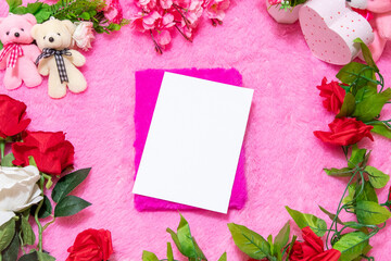 White blank notebook paper above a pink covered notebook surrounded by valentine themed decorations