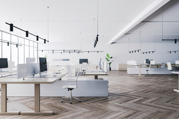 Side view on modern open space office with light furniture, wooden workspace tables, parquet floor, high ceiling with black hanging lamps and light wall background. 3D rendering