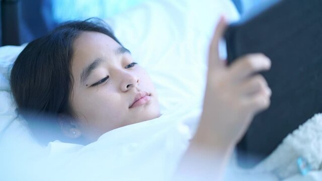 Women using mobile phones in bed, Girls playing tablets in bed in the bedroom