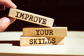 Wooden blocks with words 'Improve Your Skills'.