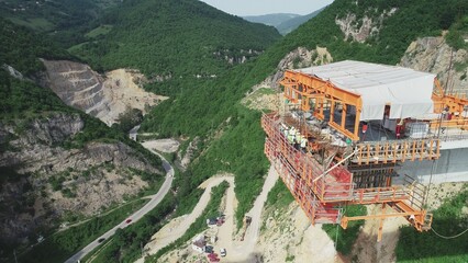 Aerial drone view on highway bridge road under construction. Construction of the viaduct on the...