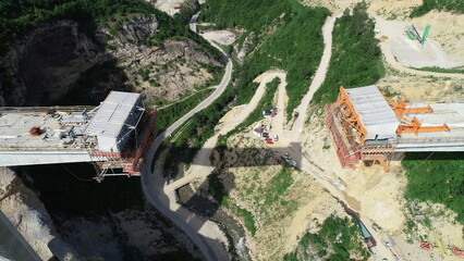 Aerial drone view on highway bridge road under construction. Construction of the viaduct on the...