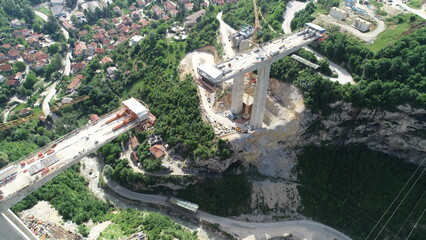 Aerial drone view on highway bridge road under construction. Construction of the viaduct on the...