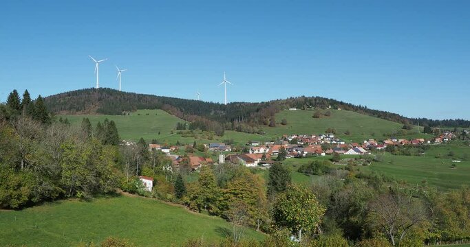 Black Forest landscapes in Southern Germany. Gersbach, village in forested mountains, slopes and hills with green pastures surrounded by the massif of Rohrenkopf und its wind turbines
