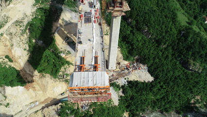 Aerial drone view on highway bridge road under construction. Construction of the viaduct on the...