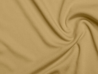 gold color velvet fabric texture used as background. blond color fabric background of soft and smooth textile material. There is space for text.