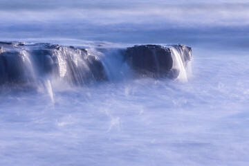 time lapse of waves over sea rocks