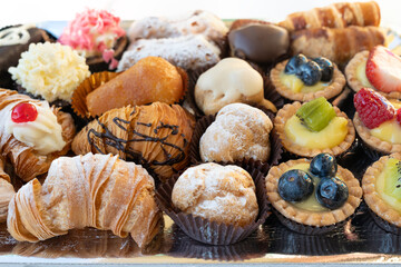 Assortment of delicious and colorful pastries, made by pastry chef. All look tasty and delightful. Perfect for a party. Natural light