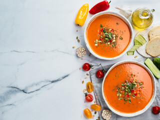 Gaspacho soup on light marble, top view