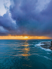 Rain clouds and storm light sunrise seascape