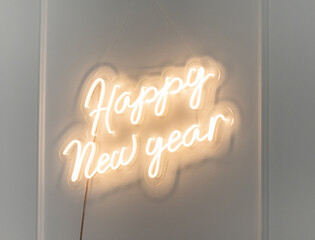 Christmas decor. A flexible neon sign with the words Happy New Year hanging on the wall