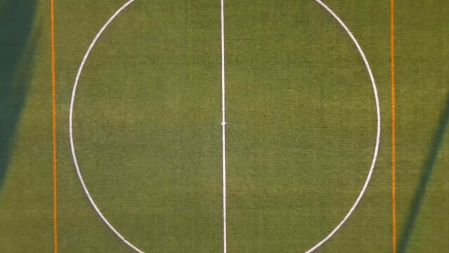 Close up drone shot flying upwards and revealing an entire football field during golden hour in Santa Ponsa, Mallorca, Spain.