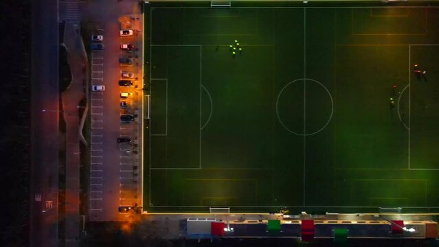 Straight down shot of a football field in the dark with lights sliding right in Santa Ponsa, Mallorca, Spain.