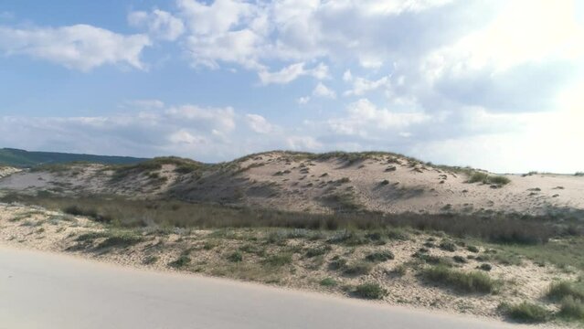 Fast aerial view flying over the beach and sand dunes in Los Canos de Meca Spain